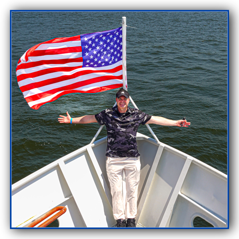 SAFETY a person standing next to a body of water in front of a flag