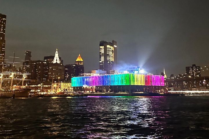 a large body of water with a city in the background