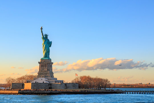 Statue of Liberty over a body of water with a city in the background